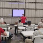 Dan Andersen leads field day class